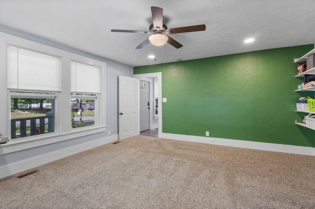 carpeted empty room with visible vents, ceiling fan, recessed lighting, and baseboards