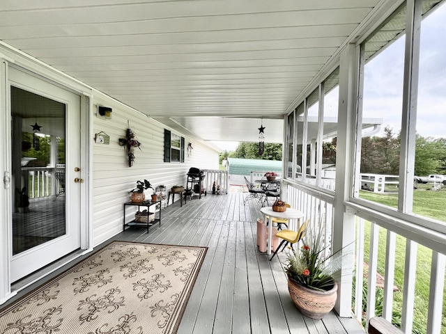 sunroom / solarium with hardwood / wood-style flooring