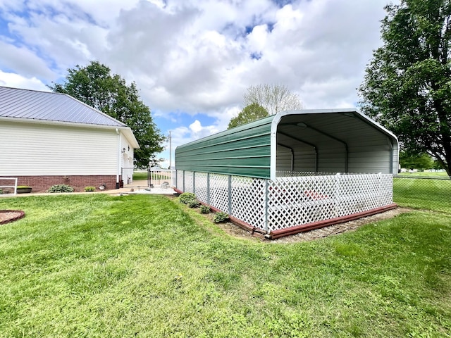 view of outbuilding with fence and a carport