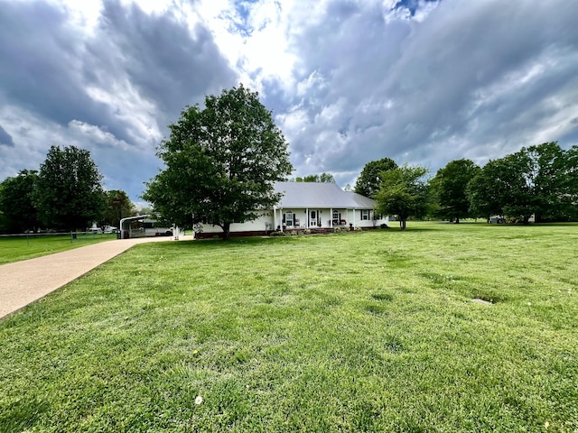 view of front of home with a front lawn and concrete driveway