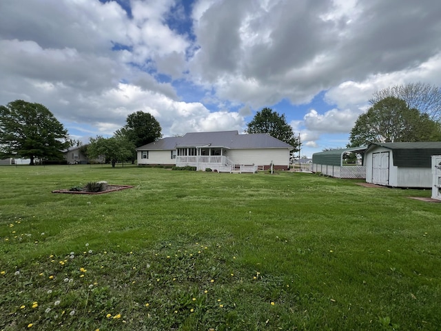 rear view of property featuring an outdoor structure, a storage shed, a wooden deck, and a lawn
