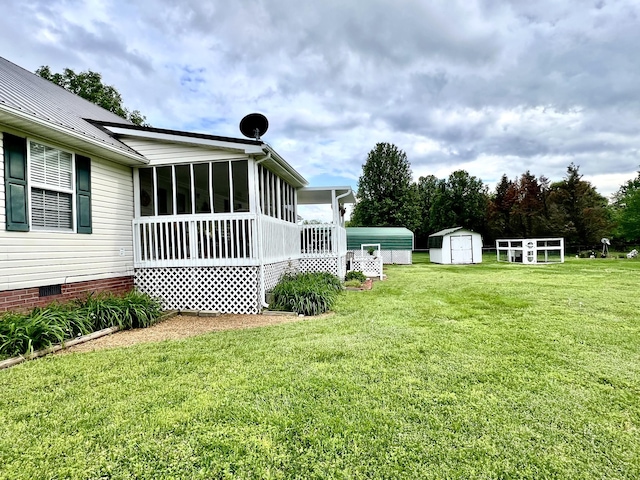 view of yard with a storage shed, an outdoor structure, and a sunroom