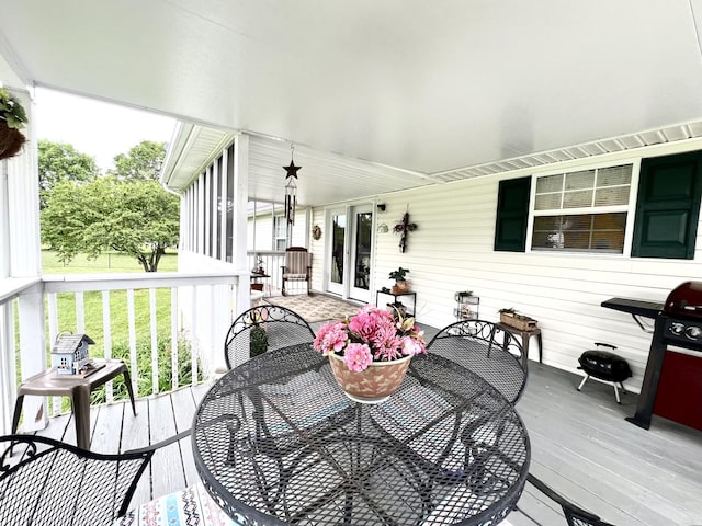 deck with outdoor dining area