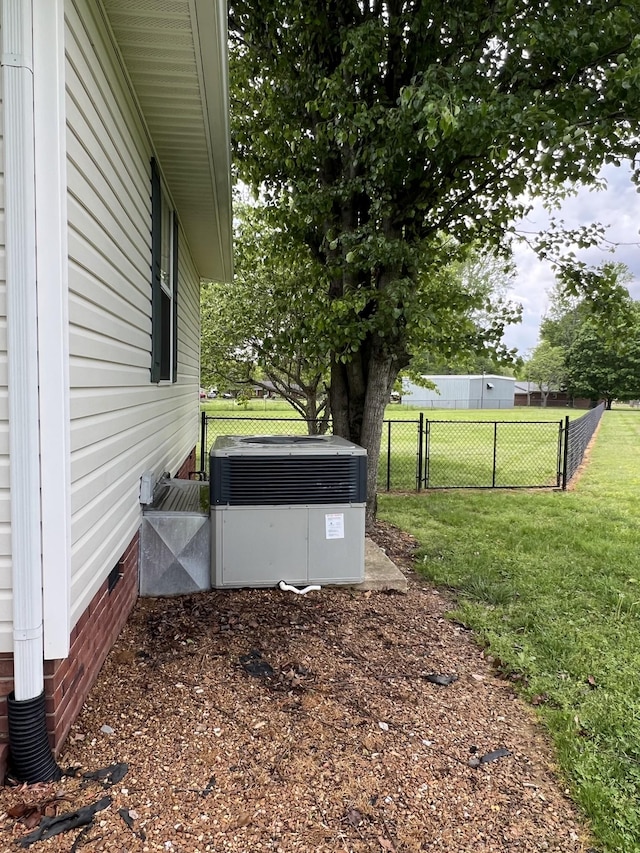 view of yard featuring fence and cooling unit
