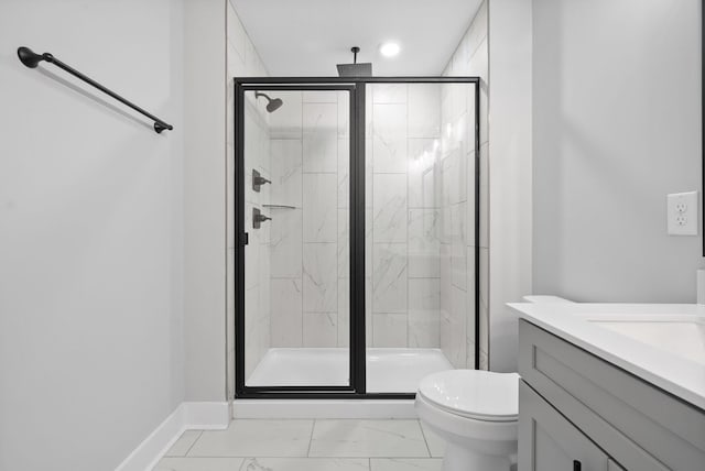 bathroom featuring a shower stall, toilet, vanity, and marble finish floor