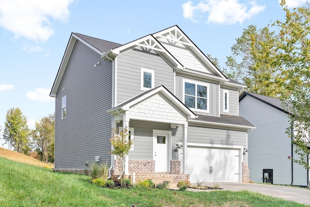 craftsman house featuring driveway, a garage, and brick siding