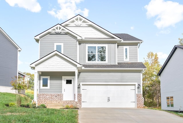 craftsman-style house featuring concrete driveway, an attached garage, and brick siding