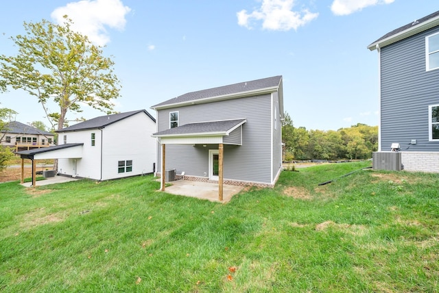 back of house with a lawn, a patio area, and central AC unit