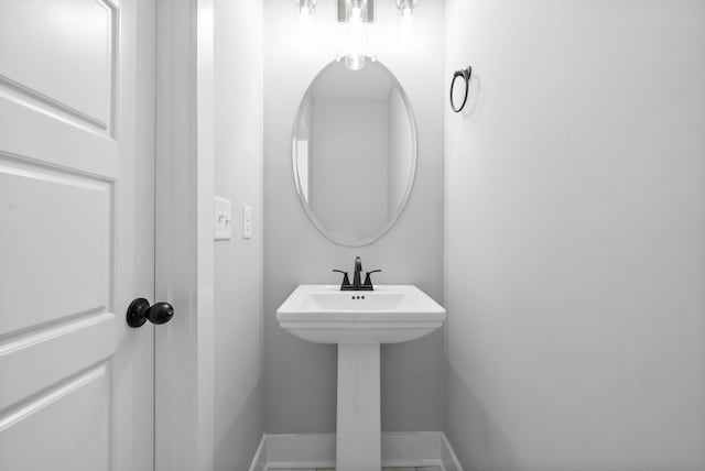 bathroom with baseboards and a sink