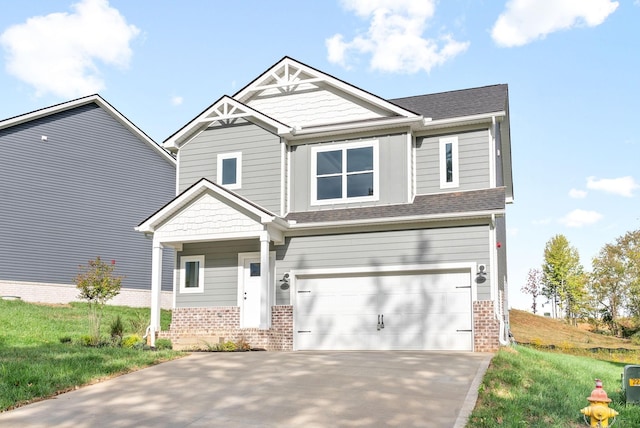 craftsman-style home with a front lawn, driveway, an attached garage, and brick siding
