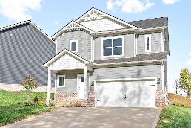 craftsman house featuring a garage, brick siding, and driveway
