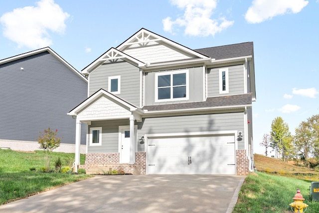 craftsman-style home featuring a garage, brick siding, a front yard, and concrete driveway
