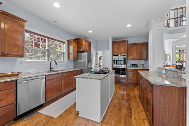 1004 Sattui Ct, Franklin, TN 37064 - kitchen with a sink, stainless steel appliances, tasteful backsplash, light wood-style flooring, and plenty of natural light