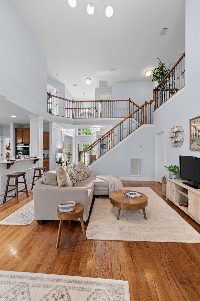 1004 Sattui Ct, Franklin, TN 37064 - living area with a towering ceiling, stairs, and visible vents
