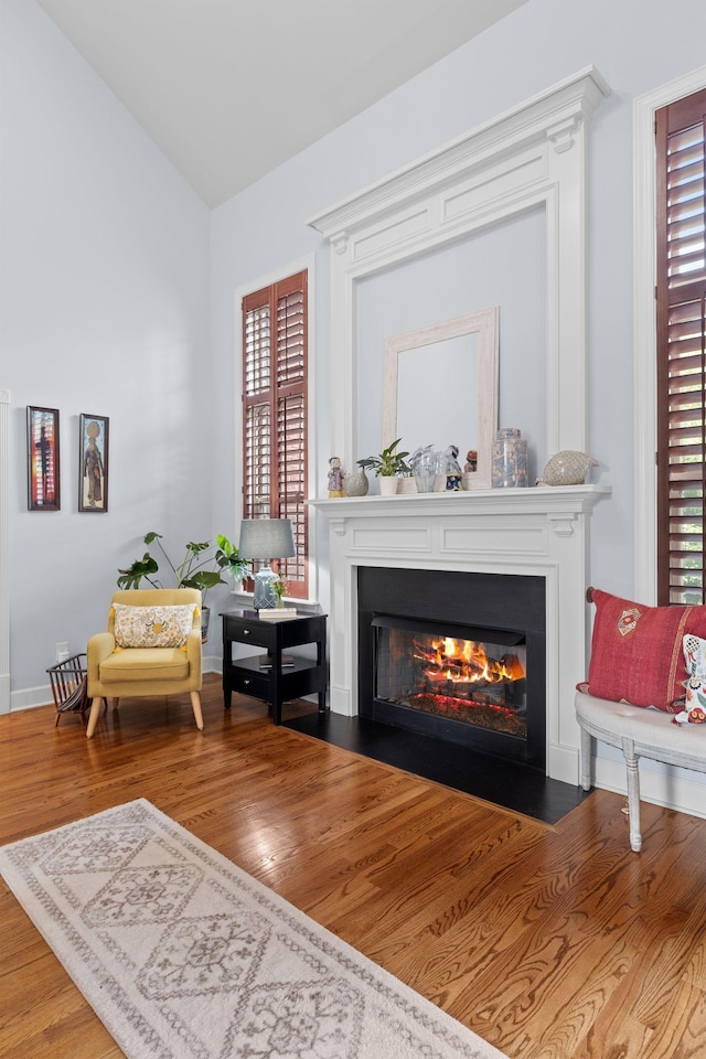 1004 Sattui Ct, Franklin, TN 37064 - living area with a fireplace with flush hearth, wood finished floors, baseboards, and lofted ceiling