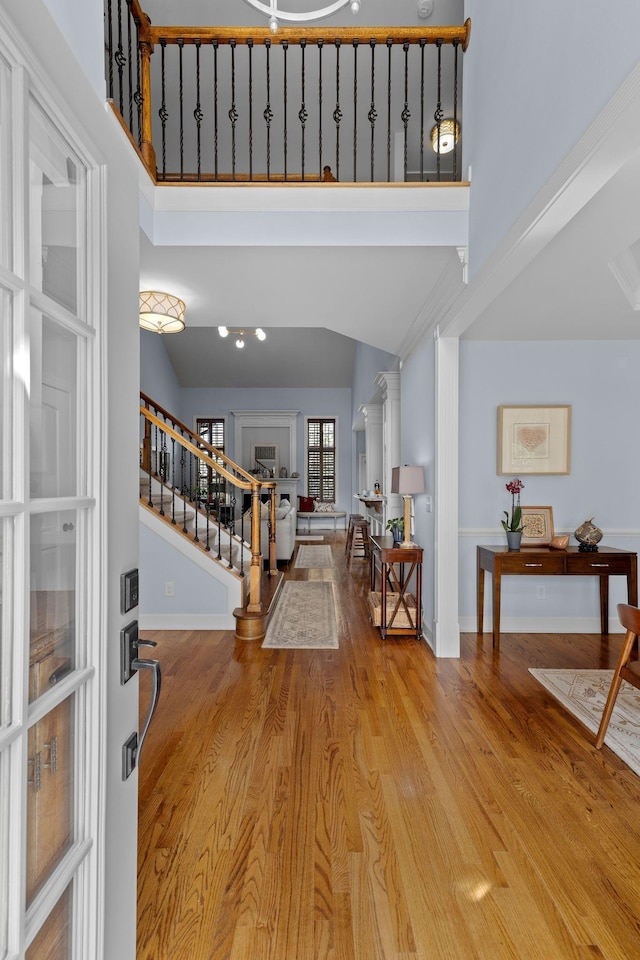 1004 Sattui Ct, Franklin, TN 37064 - entrance foyer featuring wood finished floors, baseboards, a high ceiling, and stairs