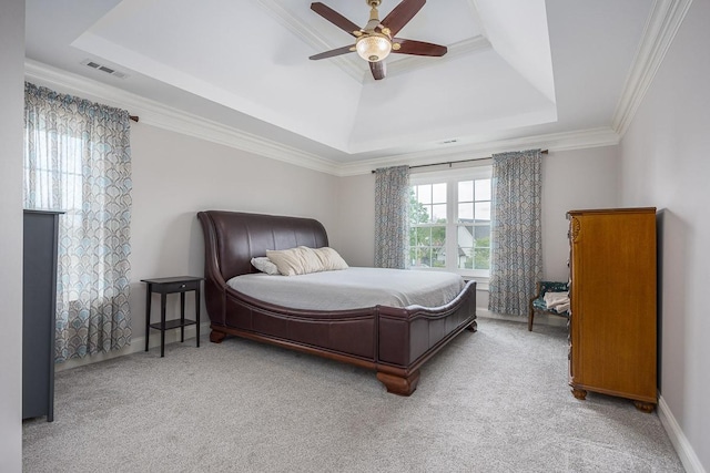 carpeted bedroom featuring crown molding, baseboards, visible vents, and a raised ceiling
