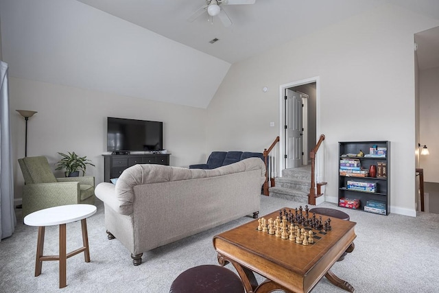 living area with ceiling fan, light colored carpet, baseboards, lofted ceiling, and visible vents