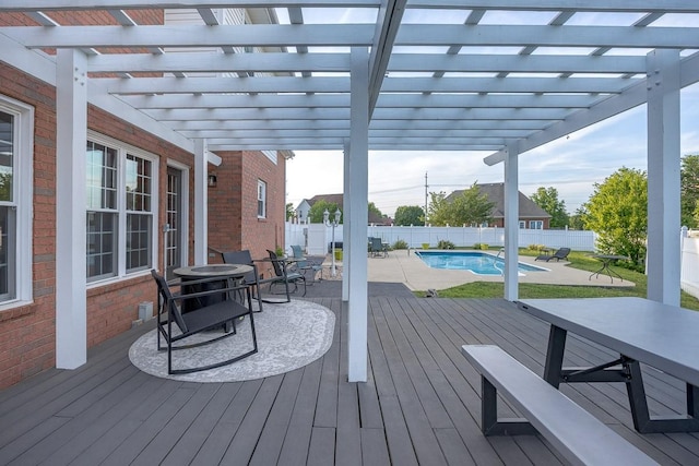 deck featuring a pergola, a fenced in pool, outdoor dining area, and a fenced backyard