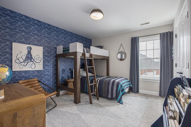 bedroom featuring baseboards, carpet, wallpapered walls, and visible vents