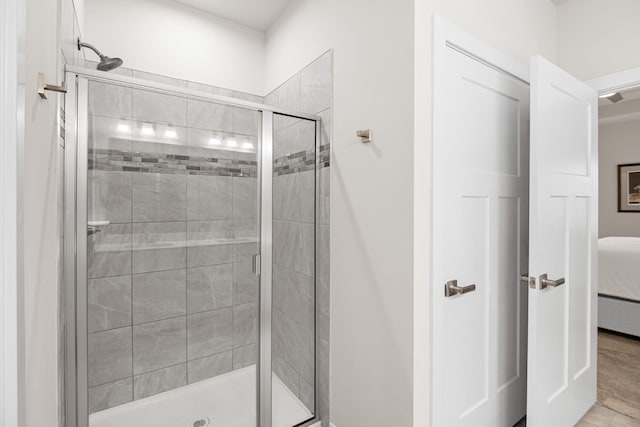 ensuite bathroom featuring ensuite bathroom and a shower stall
