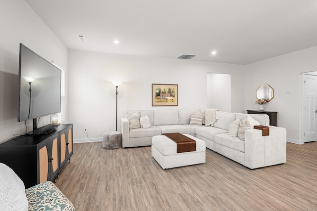 living area featuring recessed lighting, baseboards, visible vents, and wood finished floors