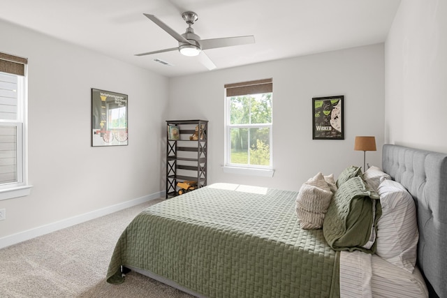 bedroom with baseboards, carpet flooring, a ceiling fan, and visible vents