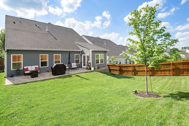 rear view of house with a lawn, an outdoor living space, fence private yard, and a patio area