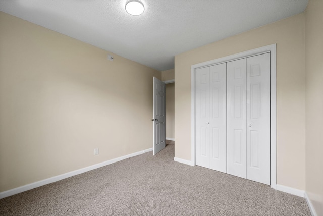 3844 Marla Cir, Clarksville, TN 37042 - unfurnished bedroom featuring carpet, a closet, a textured ceiling, and baseboards