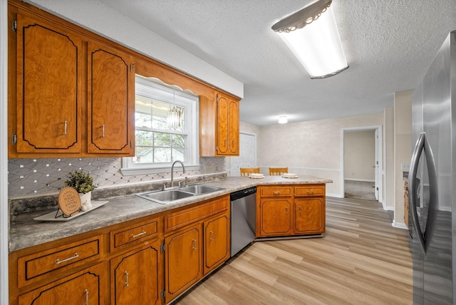 3844 Marla Cir, Clarksville, TN 37042 - kitchen with appliances with stainless steel finishes, brown cabinets, decorative backsplash, and a sink
