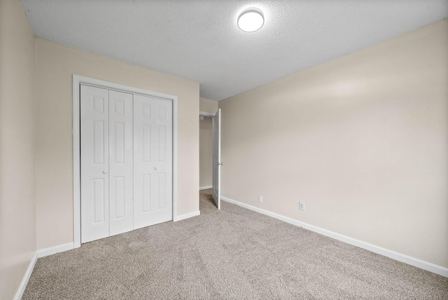 3844 Marla Cir, Clarksville, TN 37042 - unfurnished bedroom featuring a closet, a textured ceiling, carpet floors, and baseboards