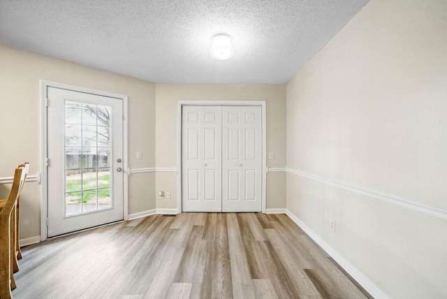3844 Marla Cir, Clarksville, TN 37042 - unfurnished bedroom with a closet, access to exterior, baseboards, a textured ceiling, and wood finished floors