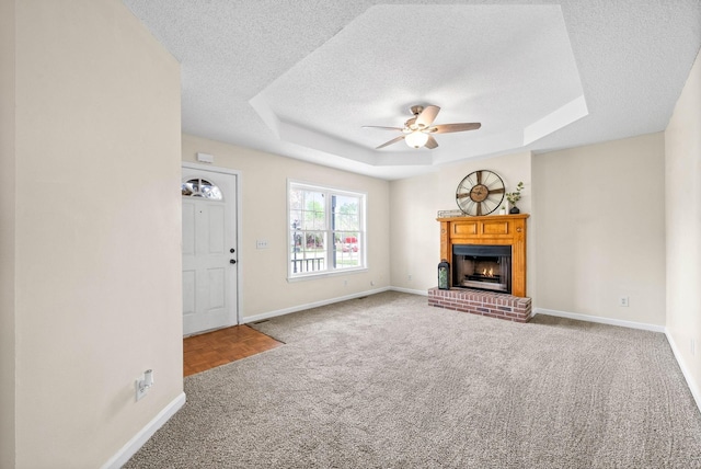 3844 Marla Cir, Clarksville, TN 37042 - unfurnished living room featuring baseboards, a ceiling fan, a textured ceiling, and a tray ceiling