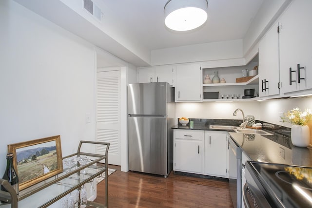 3901 Whitland Ave # 11, Nashville, TN 37205 - kitchen with stainless steel appliances, dark countertops, dark wood-style flooring, a sink, and visible vents
