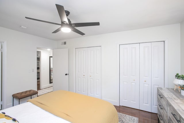 3901 Whitland Ave # 11, Nashville, TN 37205 - bedroom with dark wood-style floors, two closets, a ceiling fan, visible vents, and baseboards