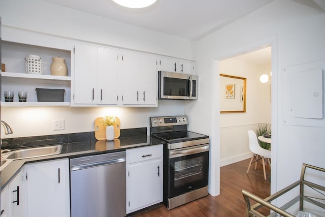 3901 Whitland Ave # 11, Nashville, TN 37205 - kitchen with dark wood finished floors, stainless steel appliances, open shelves, a sink, and white cabinetry