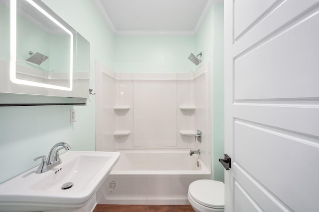 bathroom featuring toilet, shower / tub combination, crown molding, and a sink