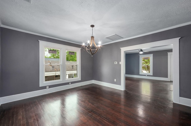 spare room with visible vents, hardwood / wood-style flooring, a textured ceiling, and crown molding