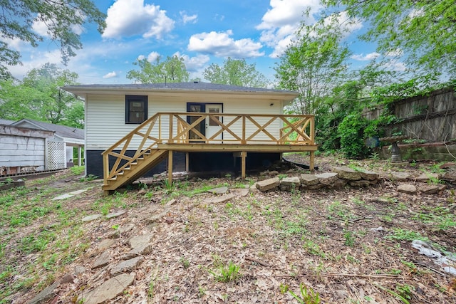 back of property with fence, stairs, and a wooden deck