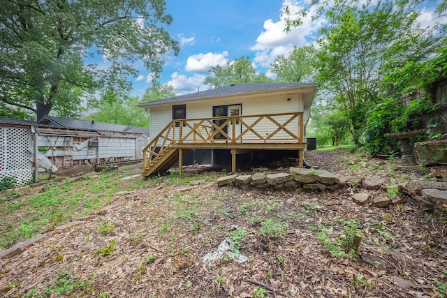 back of house featuring a wooden deck and stairs