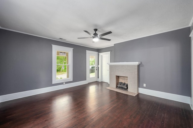 unfurnished living room featuring wood finished floors, a fireplace, baseboards, visible vents, and a ceiling fan