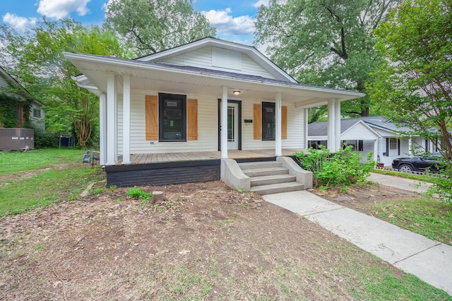 bungalow-style home with covered porch and a front yard