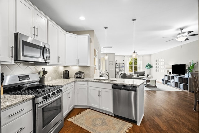 123 Saddlewood Ln, Hendersonville, TN 37075 - kitchen with a peninsula, open floor plan, white cabinets, tasteful backsplash, and appliances with stainless steel finishes
