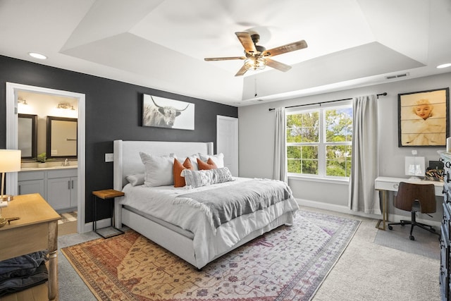 123 Saddlewood Ln, Hendersonville, TN 37075 - bedroom featuring a sink, baseboards, ensuite bathroom, a tray ceiling, and visible vents