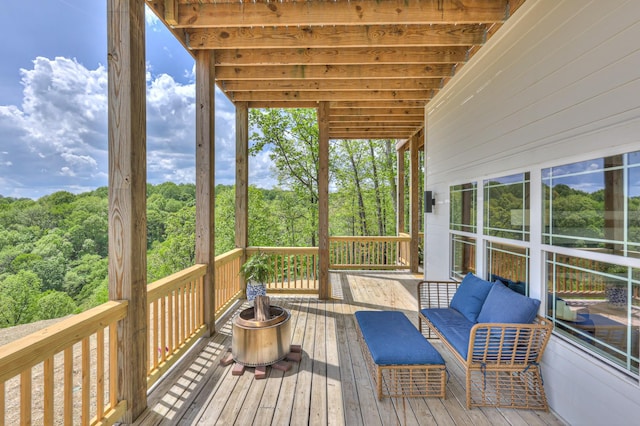 wooden deck featuring a forest view