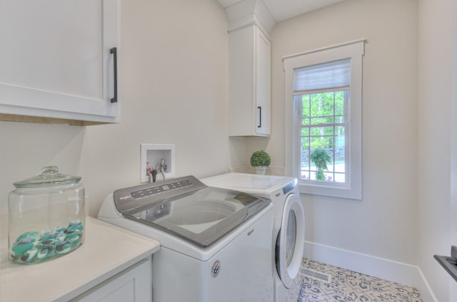 laundry area featuring baseboards, cabinet space, and washing machine and dryer