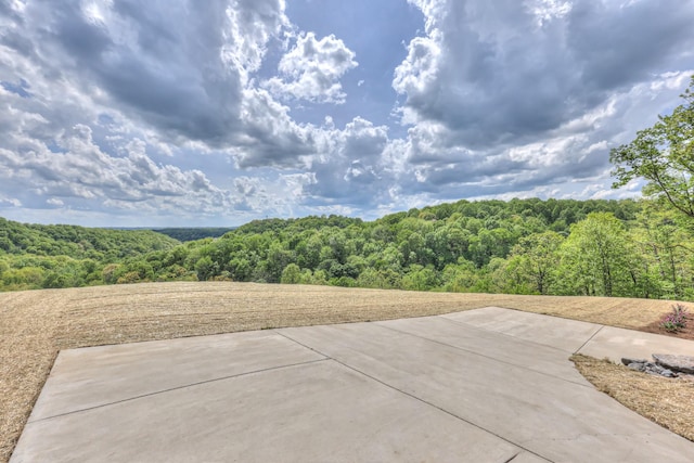 view of patio featuring a wooded view