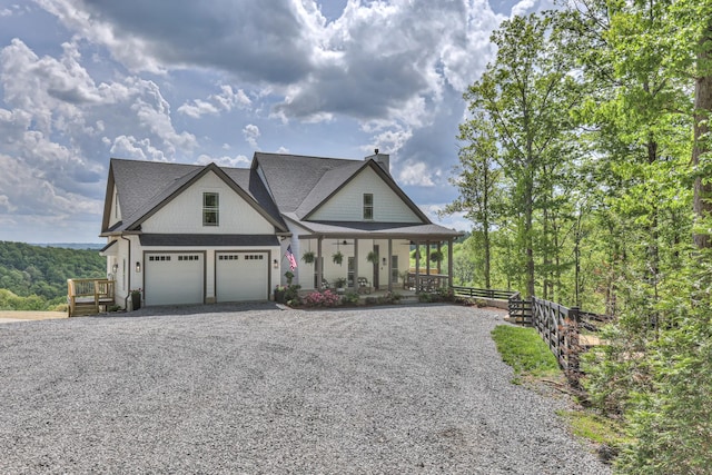 view of front of house with gravel driveway, covered porch, and a chimney