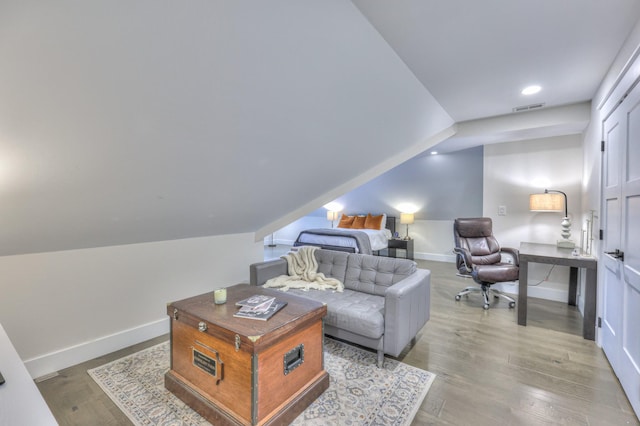 living area featuring wood finished floors, visible vents, recessed lighting, and baseboards
