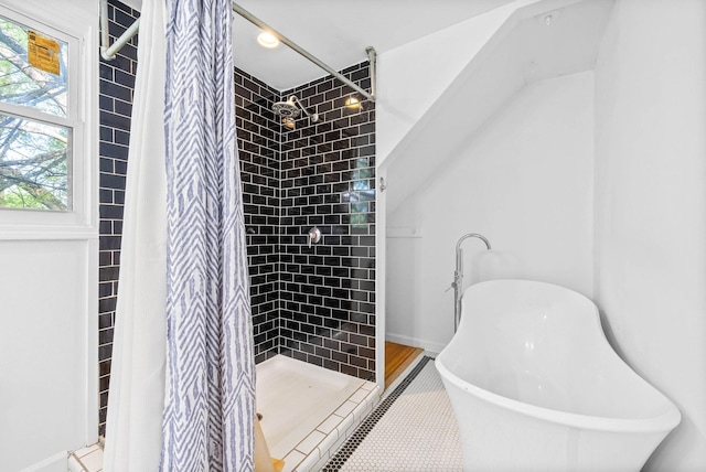 full bathroom with a freestanding bath and a shower stall